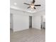 A bedroom featuring neutral tones, a ceiling fan, and an open doorway to a walk-in closet at 2041 Sw 178Th Lane Rd, Ocala, FL 34473
