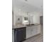Kitchen island with granite countertops, stainless steel dishwasher, sink, and white cabinets at 2041 Sw 178Th Lane Rd, Ocala, FL 34473