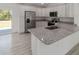 Modern kitchen showcasing granite countertops, stainless steel refrigerator, and ample storage at 2041 Sw 178Th Lane Rd, Ocala, FL 34473