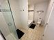 Well-lit bathroom featuring a tiled shower with glass door, bathtub, and modern fixtures at 225 Celebration Pl # 527, Kissimmee, FL 34747