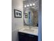 Close-up of a bathroom vanity featuring modern fixtures, decorative mirror, and contemporary design at 225 Celebration Pl # 527, Kissimmee, FL 34747