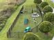 Aerial view of a fenced dog park with agility equipment, picnic tables, and manicured landscaping at 225 Celebration Pl # 527, Kissimmee, FL 34747