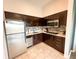 Efficient kitchen with stainless steel appliances, dark wood cabinets, and neutral backsplash, ready for cooking and entertaining at 225 Celebration Pl # 527, Kissimmee, FL 34747