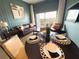 Cozy living room with dining area, leather sofa, throw pillows, modern art, and a balcony with outdoor seating at 225 Celebration Pl # 527, Kissimmee, FL 34747
