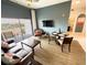 Inviting living room with a comfy leather sofa, a flat-screen TV, balcony with chairs, and adjacent to a dining area at 225 Celebration Pl # 527, Kissimmee, FL 34747