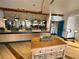 Inviting restaurant interior with modern lighting, wood accents, plants, and a peek into the dining area at 225 Celebration Pl # 527, Kissimmee, FL 34747
