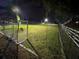 Night view of a soccer field with stadium lighting, nets, and distant goals, creating a recreational sports space at 225 Celebration Pl # 527, Kissimmee, FL 34747
