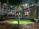 Outdoor spa area at night, featuring lush tropical landscaping and ambient lighting at 225 Celebration Pl # 527, Kissimmee, FL 34747