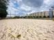 Scenic sand volleyball court with the Melia Rewards building in the background and a cloudy sky at 225 Celebration Pl # 527, Kissimmee, FL 34747