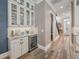 Stylish bar area features custom cabinets, granite countertops and a wine refrigerator at 242 W Lyman Ave, Winter Park, FL 32789