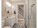 Modern bathroom with a glass-enclosed shower, decorative tile floors, and an open doorway to the staircase at 242 W Lyman Ave, Winter Park, FL 32789