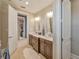 Bathroom featuring a double sink vanity, tile floors, and an open doorway to the walk-in closet at 242 W Lyman Ave, Winter Park, FL 32789