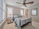 Bedroom with a cozy bed, ample natural light from the shuttered windows, and a ceiling fan at 242 W Lyman Ave, Winter Park, FL 32789
