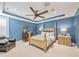 Spacious bedroom featuring a four-poster bed, blue walls, and a ceiling fan at 242 W Lyman Ave, Winter Park, FL 32789