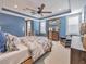 Cozy bedroom with blue walls, a ceiling fan, and comfortable furniture at 242 W Lyman Ave, Winter Park, FL 32789