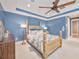 Bright bedroom with a four-poster bed, blue walls, and a ceiling fan at 242 W Lyman Ave, Winter Park, FL 32789