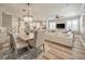 This well-lit dining room flows into the kitchen and living room and features a decorative chandelier at 242 W Lyman Ave, Winter Park, FL 32789