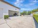 Spacious driveway leading to an open garage and gated entrance, enhanced by lush greenery at 242 W Lyman Ave, Winter Park, FL 32789