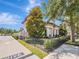 Beautiful home featuring manicured landscaping, wrought iron fence and a paver driveway at 242 W Lyman Ave, Winter Park, FL 32789
