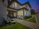 Twilight shot showcasing a landscaped yard with outdoor kitchen and seating area at 242 W Lyman Ave, Winter Park, FL 32789