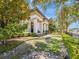 A charming two-story home featuring meticulously maintained landscaping with stone and greenery at 242 W Lyman Ave, Winter Park, FL 32789