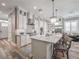 Gorgeous kitchen with a huge island and a clear view to the home's entry, living room, and dining area at 242 W Lyman Ave, Winter Park, FL 32789