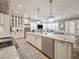 Bright kitchen featuring stainless appliances, granite countertops, custom white cabinets and a view into the living area at 242 W Lyman Ave, Winter Park, FL 32789