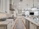 Modern kitchen with stainless appliances, granite countertops, a large island and a view into the living room at 242 W Lyman Ave, Winter Park, FL 32789