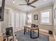 Bright office space with a ceiling fan, natural light from the windows, and a gray textured rug at 242 W Lyman Ave, Winter Park, FL 32789
