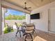 Relaxing covered patio featuring comfortable seating, an outdoor TV, and bright natural lighting at 242 W Lyman Ave, Winter Park, FL 32789