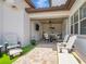 Covered outdoor living space with an outdoor kitchen, a TV, and seating area for entertaining at 242 W Lyman Ave, Winter Park, FL 32789
