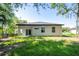 Expansive backyard view showcases the home's back exterior, featuring windows and a sliding glass door at 25 W 7Th St, Apopka, FL 32703