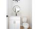 Well-lit half-bath with modern vanity, round mirror, and contemporary black hardware at 25 W 7Th St, Apopka, FL 32703