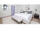 Tranquil bedroom featuring a plush bed, a bench, side tables, lamps, and modern decor at 25 W 7Th St, Apopka, FL 32703