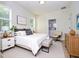 Cozy bedroom featuring a bed with neutral bedding, side tables, lamps, and ensuite bathroom access at 25 W 7Th St, Apopka, FL 32703