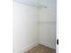Empty walk-in closet features wire shelves, wood-look floors, and white paint at 25 W 7Th St, Apopka, FL 32703