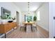 Bright dining room featuring a long wooden table, six chairs, modern decor, and light wood flooring at 25 W 7Th St, Apopka, FL 32703