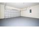 Spacious two car garage with concrete floors and walls, featuring a sectional garage door at 25 W 7Th St, Apopka, FL 32703