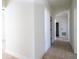 View of the hallway showing wood-look floors and doors throughout the home at 25 W 7Th St, Apopka, FL 32703