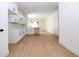 Open-concept kitchen boasts white cabinets, modern backsplash, and sleek black hardware and lighting at 25 W 7Th St, Apopka, FL 32703