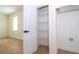 Bright pantry featuring white wire shelves and door; washer and dryer hookups in adjacent room at 25 W 7Th St, Apopka, FL 32703