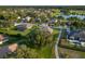 A home on a well manicured lot, featuring a screened in pool and lush greenery at 25859 Crossings Bluff Ln, Sorrento, FL 32776