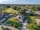 Expansive home with a lush lawn, screened in porch, and paver driveway in a golf course community at 25859 Crossings Bluff Ln, Sorrento, FL 32776