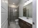 Bathroom features a dark wooden vanity and a standing shower with gray tile at 25859 Crossings Bluff Ln, Sorrento, FL 32776