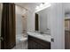 Bathroom features a dark wooden vanity and a shower-tub with a dark curtain at 25859 Crossings Bluff Ln, Sorrento, FL 32776