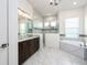 Elegant bathroom featuring double vanity, soaking tub, and luxurious tiled walk-in shower at 25859 Crossings Bluff Ln, Sorrento, FL 32776