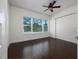 Bright bedroom features hardwood floors, ceiling fan, and large closet space at 25859 Crossings Bluff Ln, Sorrento, FL 32776