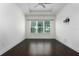Bright bedroom with hardwood floors, tray ceiling and large window overlooking backyard at 25859 Crossings Bluff Ln, Sorrento, FL 32776