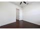 Neutral bedroom with open door, hard wood floors and a ceiling fan at 25859 Crossings Bluff Ln, Sorrento, FL 32776