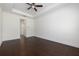 Spacious bedroom featuring hardwood floors, a modern ceiling fan, and neutral paint at 25859 Crossings Bluff Ln, Sorrento, FL 32776